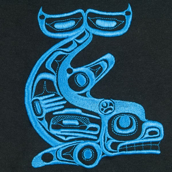 The Killer Whale, designed by Yukie Adams, is embroidered in blue on the black shirt.