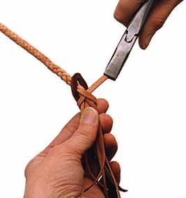 With the strand on the left, tie a half-hitch around the fall and other strands in the direction shown and pull tight. With short strands use pliers to pull the strands tight.