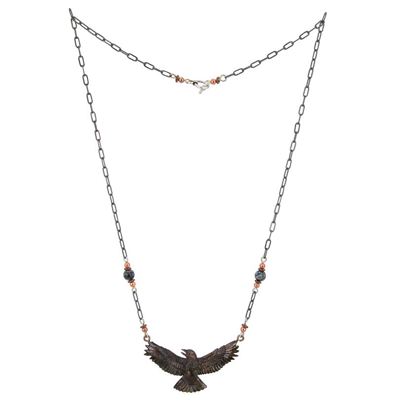 Copper, heishi and snowflake obsidian beads decorate the 20 inch antiqued silver chain of the Crow Necklace.